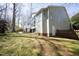 Back exterior view of the home with a walkout deck and a well manicured lawn at 1705 Mcrae Pl, Hillsborough, NC 27278