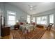 A spacious bedroom with a ceiling fan, wood floors, and plenty of natural light at 1705 Mcrae Pl, Hillsborough, NC 27278