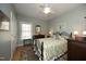 Comfortable bedroom with a ceiling fan, hardwood floors, and a closet at 1705 Mcrae Pl, Hillsborough, NC 27278