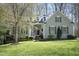 Charming home with a well-manicured lawn, complemented by decorative shutters and tasteful landscaping at 1705 Mcrae Pl, Hillsborough, NC 27278
