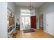 Bright foyer with a hardwood floor, an open doorway, and decor, creating an inviting entrance at 1705 Mcrae Pl, Hillsborough, NC 27278
