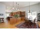 Well-lit kitchen featuring an island, dining table, and built-in wooden cabinets at 1705 Mcrae Pl, Hillsborough, NC 27278