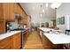 Contemporary kitchen with wooden cabinets, quartz countertops, and stainless steel appliances at 1705 Mcrae Pl, Hillsborough, NC 27278