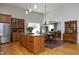 Open-concept kitchen with a wooden island, stainless steel appliances, and a dining area at 1705 Mcrae Pl, Hillsborough, NC 27278