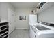This functional laundry room has a washer, dryer, refrigerator, and shelving for storage at 1705 Mcrae Pl, Hillsborough, NC 27278