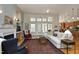 Spacious living area with a white sofa, fireplace, and access to a bright outdoor space at 1705 Mcrae Pl, Hillsborough, NC 27278
