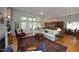 Cozy living room with a fireplace, plush seating, and an open layout connected to the kitchen at 1705 Mcrae Pl, Hillsborough, NC 27278