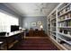 Bright office with built in bookshelves, hardwood floors, and a ceiling fan at 1705 Mcrae Pl, Hillsborough, NC 27278