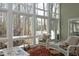 The sunroom has large windows offering views of the outdoors at 1705 Mcrae Pl, Hillsborough, NC 27278