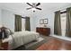 Neutral bedroom featuring hardwood floors, ceiling fan, and matching dresser at 200 Mariah Towns Way, Garner, NC 27529