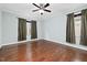 A bedroom featuring hardwood floors and two windows at 200 Mariah Towns Way, Garner, NC 27529