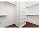 Walk-in closet with built-in shelves and ample storage space with wood trim at 200 Mariah Towns Way, Garner, NC 27529