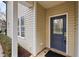 Inviting front entrance featuring a stylish blue door, modern lock, and well-kept surroundings at 200 Mariah Towns Way, Garner, NC 27529