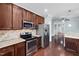 Modern kitchen featuring stainless steel appliances, granite counters, and a seamless flow to the living spaces at 200 Mariah Towns Way, Garner, NC 27529