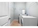 Laundry room complete with a washer, dryer, wire shelving, and tiled floor at 200 Mariah Towns Way, Garner, NC 27529