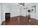 An empty living room featuring a fireplace, wood floors, light blue walls, and neutral trimwork at 200 Mariah Towns Way, Garner, NC 27529