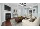 Inviting living room with a fireplace, TV, wood floors, comfortable seating, and a neutral color palette at 200 Mariah Towns Way, Garner, NC 27529
