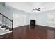 The living room features hardwood floors, staircase, a fireplace, a ceiling fan, and white trim at 200 Mariah Towns Way, Garner, NC 27529