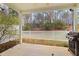 Cozy covered patio offers a grill and peaceful views of the backyard and surrounding trees at 200 Mariah Towns Way, Garner, NC 27529