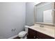 Small half-bath with a vanity, sink, mirror, toilet, and wood floors at 200 Mariah Towns Way, Garner, NC 27529