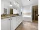 A spacious bathroom with a double vanity, soaking tub, and glass-enclosed shower, complemented by tile flooring at 2012 Castana Ct, Willow Springs, NC 27592