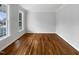 A bright bedroom with hardwood floors and large windows, offering plenty of natural light at 2012 Castana Ct, Willow Springs, NC 27592