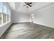 Spacious bedroom featuring a tray ceiling, ceiling fan, and large windows for plenty of light at 2012 Castana Ct, Willow Springs, NC 27592