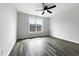 Bright bedroom with a ceiling fan, large window, and modern wood-look flooring at 2012 Castana Ct, Willow Springs, NC 27592