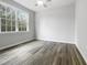 A cozy bedroom with a ceiling fan and large windows, featuring laminate wood flooring at 2012 Castana Ct, Willow Springs, NC 27592