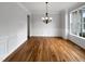 An elegant dining room with hardwood floors, wainscoting, a chandelier, and natural light at 2012 Castana Ct, Willow Springs, NC 27592