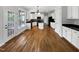 Spacious kitchen featuring white cabinets, black countertops, and stainless steel appliances, with hardwood floors at 2012 Castana Ct, Willow Springs, NC 27592