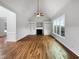 A bright living room featuring a fireplace, built-in shelving, hardwood floors, and large windows at 2012 Castana Ct, Willow Springs, NC 27592