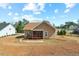 Back exterior view of home with screened in porch, patio, and expansive backyard at 203 Streamside Dr, Sanford, NC 27330