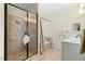 A spacious bathroom with a glass shower enclosure, soaking tub, and white vanity at 203 Streamside Dr, Sanford, NC 27330