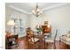 Formal dining room with hardwood floors, a chandelier, and a classic table setting at 203 Streamside Dr, Sanford, NC 27330