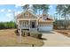 Charming home features a well-manicured lawn, inviting front porch and attached two-car garage at 203 Streamside Dr, Sanford, NC 27330