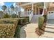 Inviting home exterior with covered front porch, manicured bushes, and walkway at 203 Streamside Dr, Sanford, NC 27330