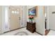 A welcoming foyer with a neutral color palette, decorative rug, and table with fresh flowers at 203 Streamside Dr, Sanford, NC 27330