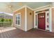 Charming front porch with decorative ceiling, wood floors, and inviting red front door at 203 Streamside Dr, Sanford, NC 27330