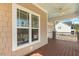 Exterior of covered porch with view of the Simplesafe security system and well-manicured lawn at 203 Streamside Dr, Sanford, NC 27330