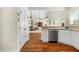 Open-concept kitchen featuring stainless steel appliances, wood floors, and seamlessly connecting to the living room at 203 Streamside Dr, Sanford, NC 27330