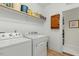 Practical laundry room with a washer, a dryer, a storage shelf, and easy access to adjacent areas at 203 Streamside Dr, Sanford, NC 27330
