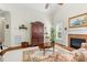 Comfortable living room featuring a fireplace, an area rug, a ceiling fan, and lots of natural light at 203 Streamside Dr, Sanford, NC 27330