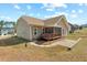 Rear exterior view of the home, showcasing a screened porch and expansive yard at 203 Streamside Dr, Sanford, NC 27330