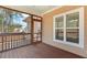 Exterior view of the screened porch, featuring wood floors, access door, and double-paned windows at 203 Streamside Dr, Sanford, NC 27330