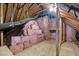 Unfinished attic space with exposed beams, ductwork, and insulation, offering potential for expansion at 205 Parliament Pl, Dunn, NC 28334