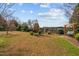 Expansive backyard featuring a swing, fence, and mature landscaping providing privacy and charm at 205 Parliament Pl, Dunn, NC 28334