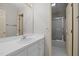 Well-lit bathroom features a white vanity with a tile shower visible in the background at 205 Parliament Pl, Dunn, NC 28334