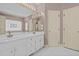 Bright bathroom features double sinks, large mirror, and white cabinets at 205 Parliament Pl, Dunn, NC 28334