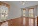 Spacious primary bedroom with hardwood floors, natural light from several windows, and neutral color palette at 205 Parliament Pl, Dunn, NC 28334